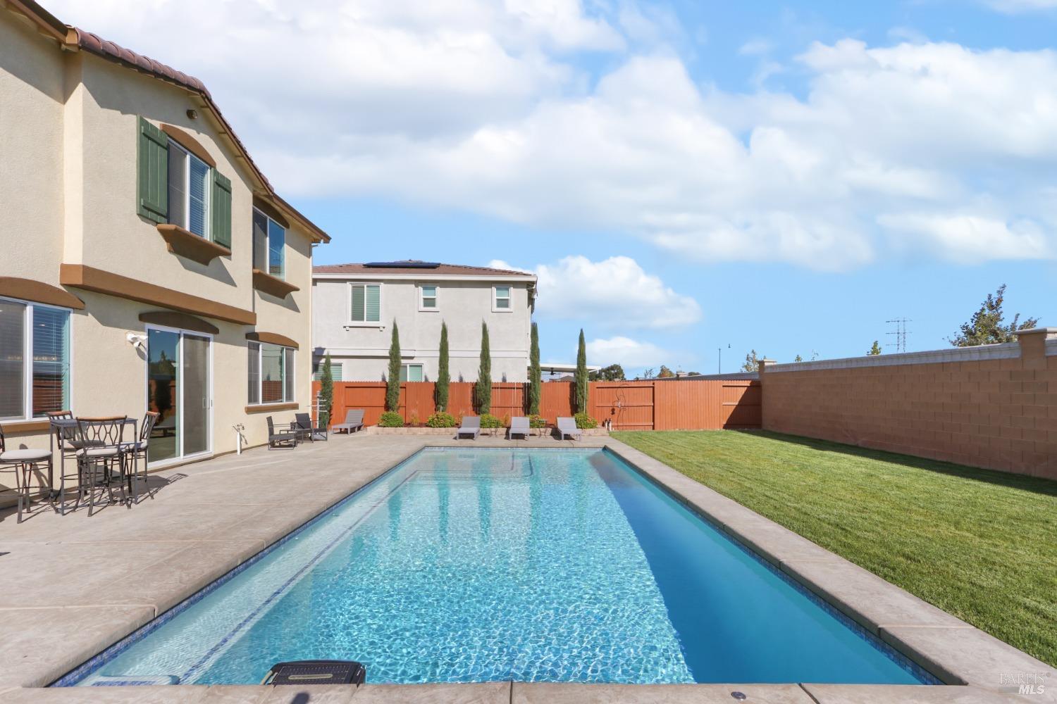 a swimming pool view with a outdoor seating