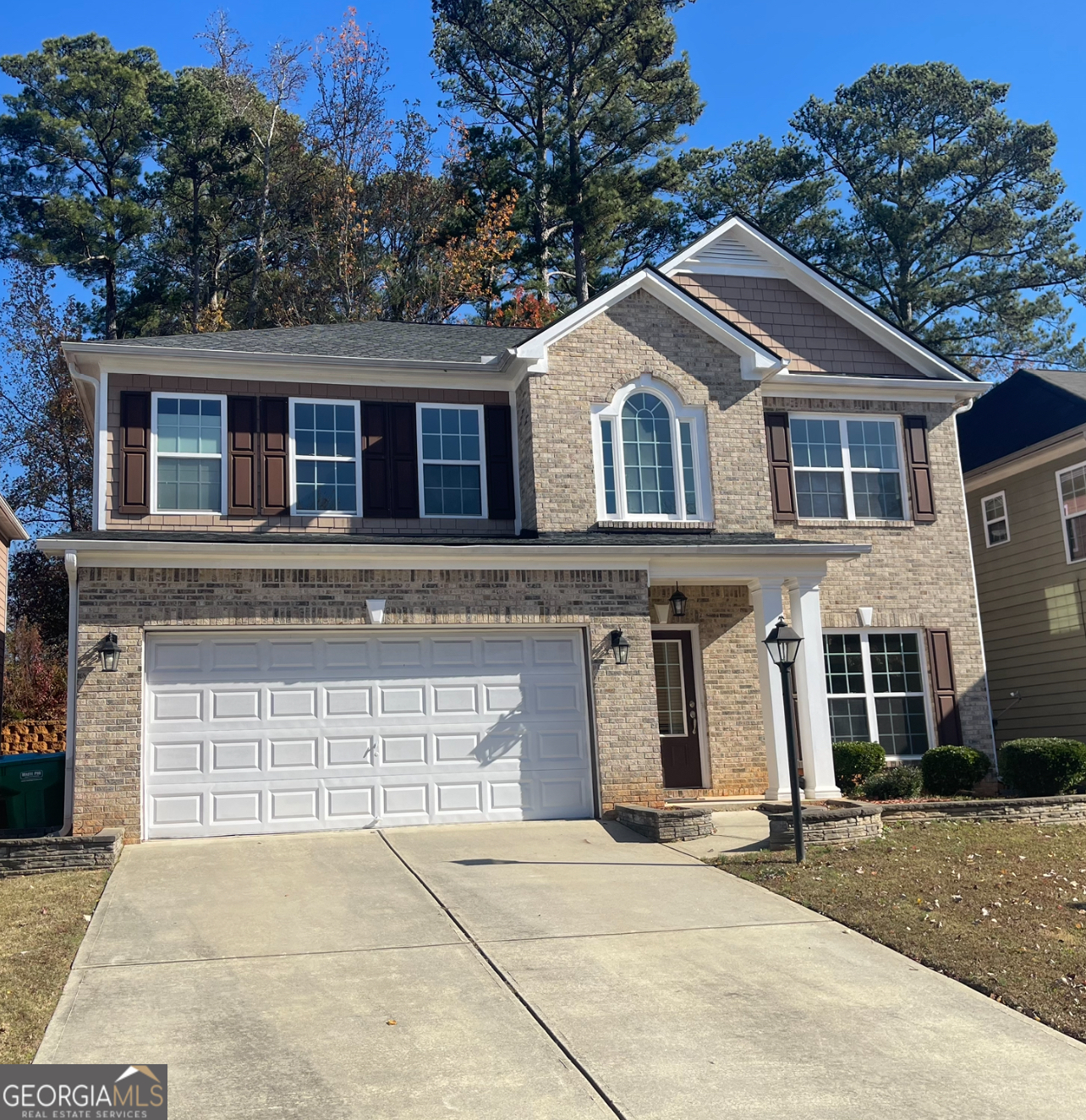 a front view of a house with a yard and garage