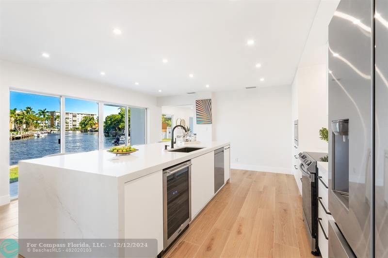 a kitchen with a sink and wooden floor