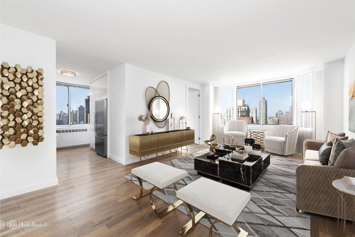 a living room with furniture kitchen view and a wooden floor