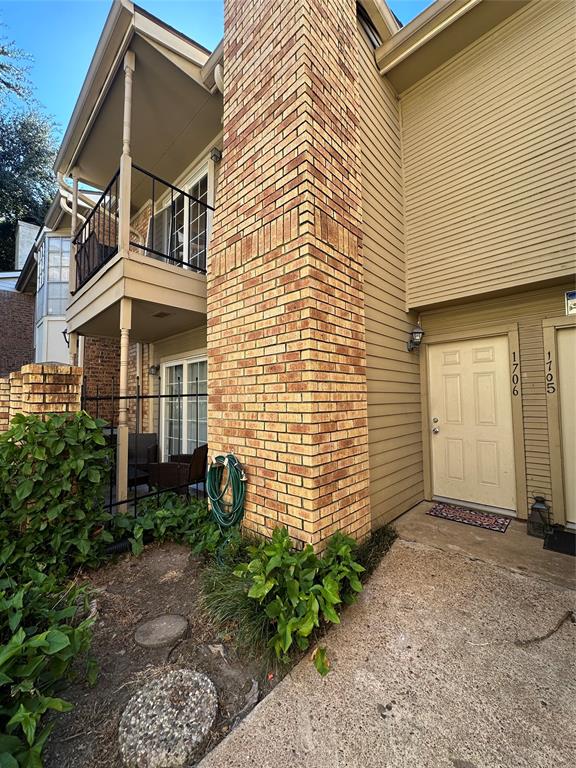 a view of a brick house with many windows