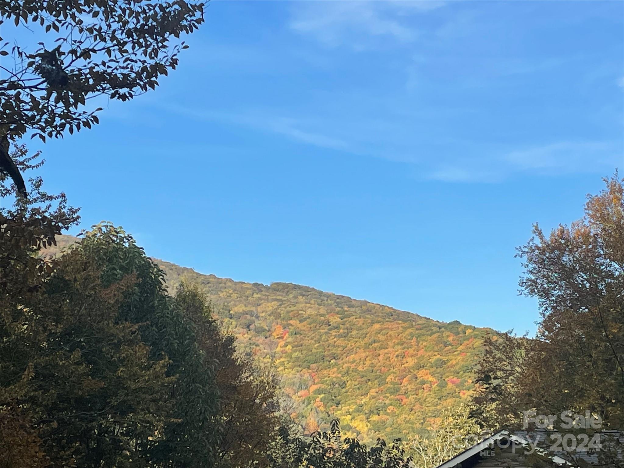 a view of a large mountain with mountains in the background