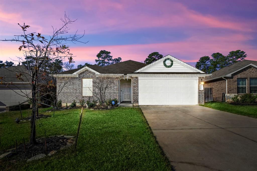 a front view of a house with a yard and garage