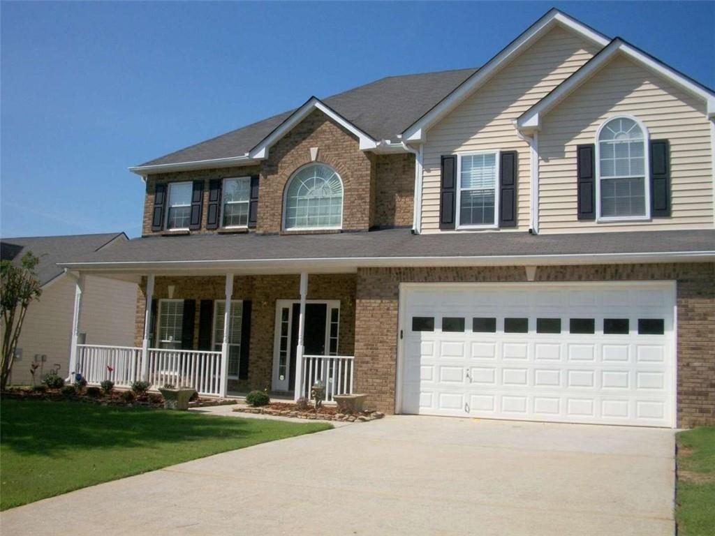 a front view of a house with a yard