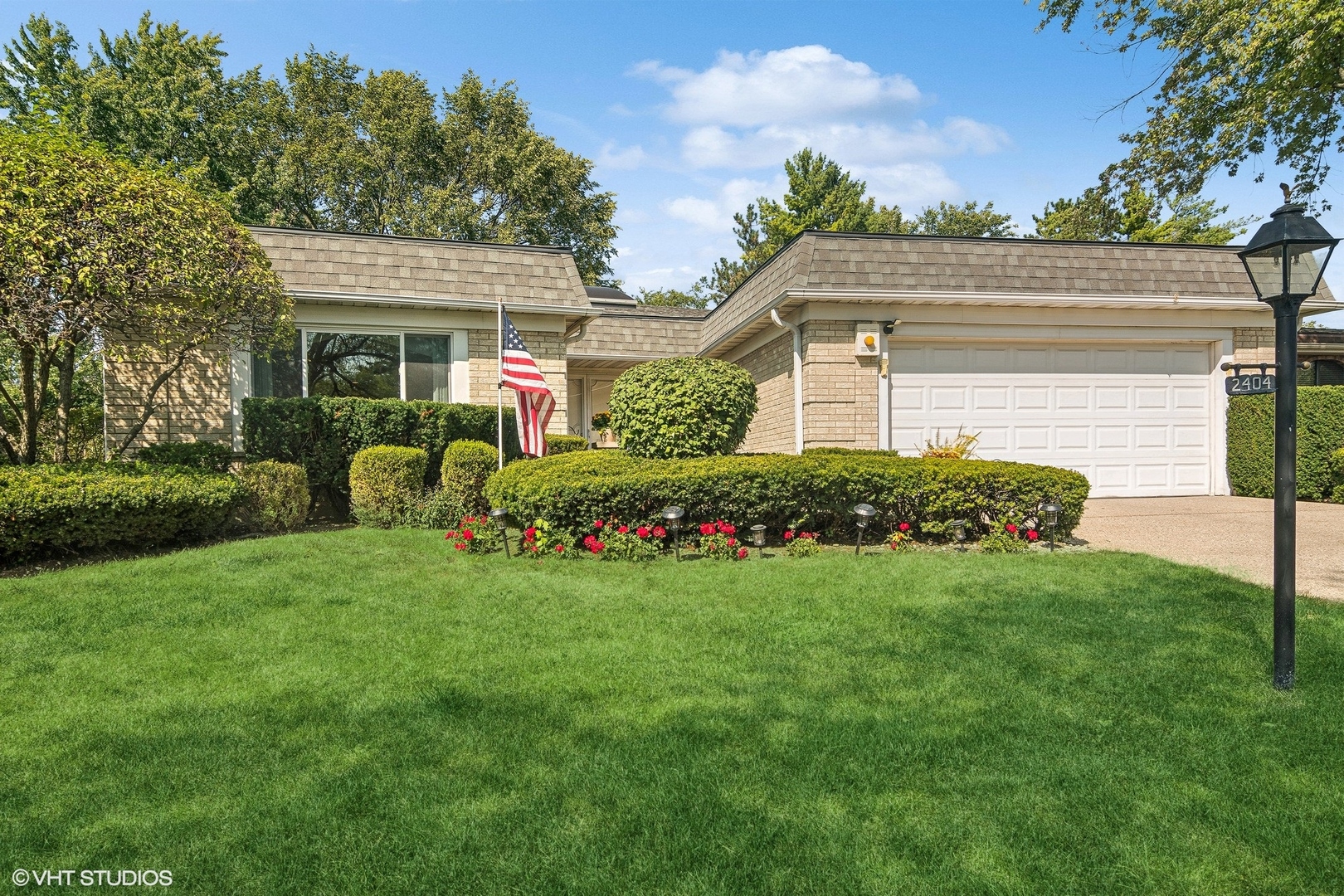 a front view of a house with a garden