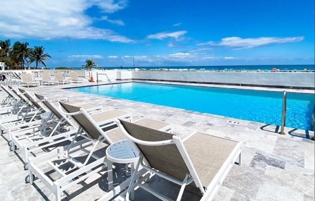 a view of a swimming pool with an outdoor seating