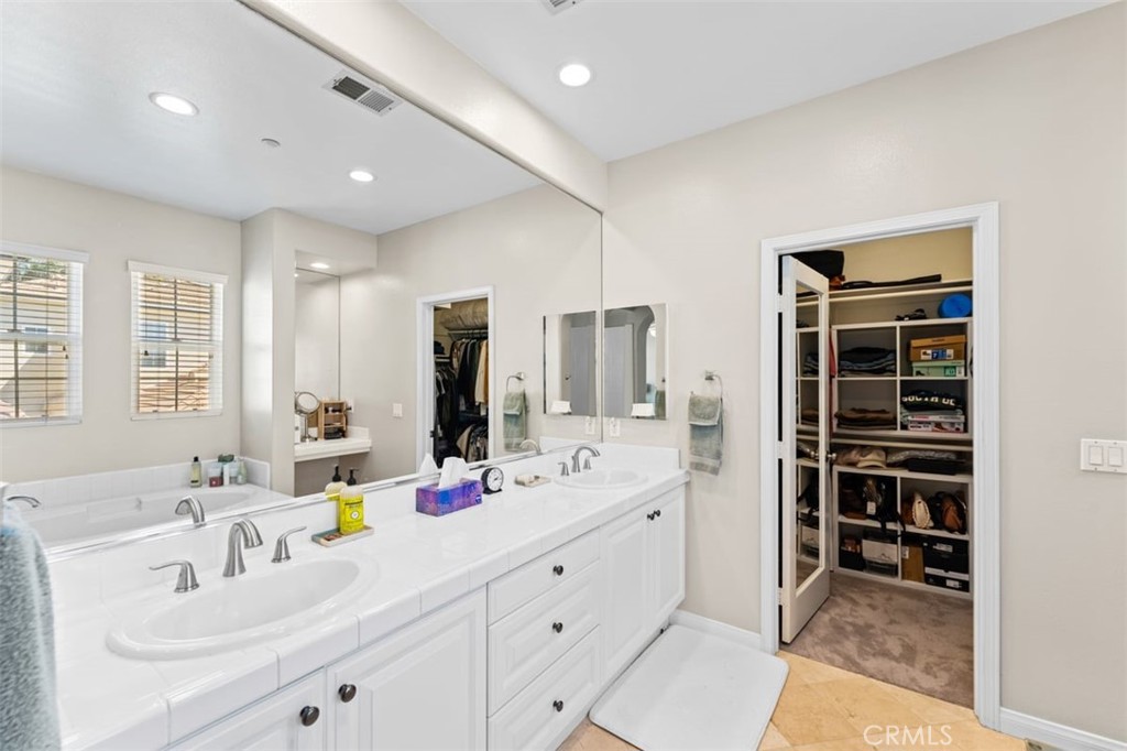 a bathroom with a double vanity sink mirror and