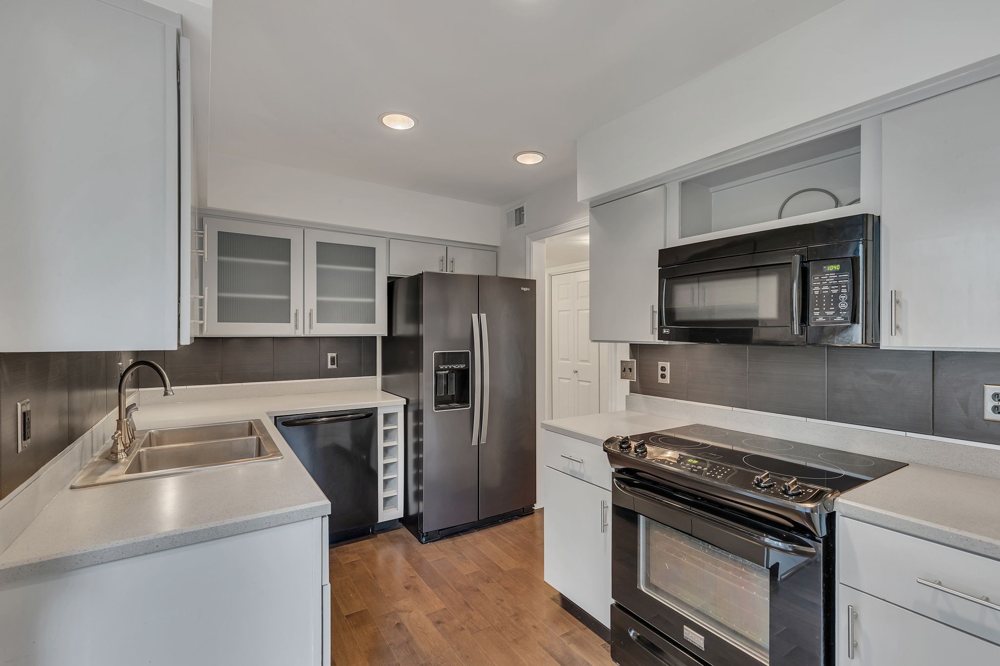 a kitchen with a sink stove and refrigerator