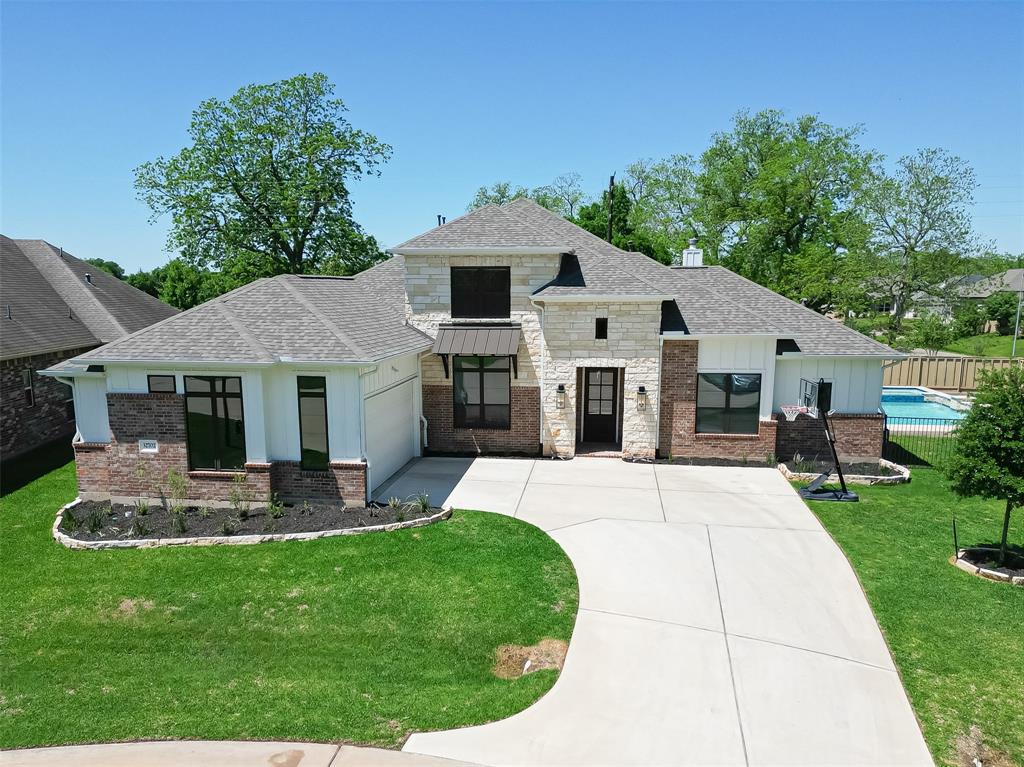 a front view of a house with a garden and patio