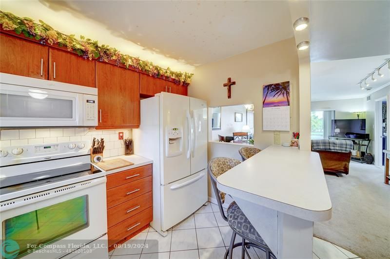 a kitchen with stainless steel appliances a stove refrigerator sink and cabinets