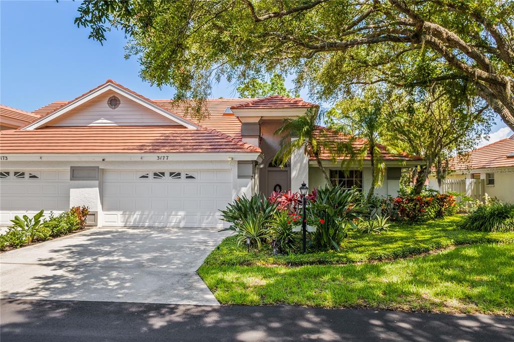 a front view of a house with a yard and a garage