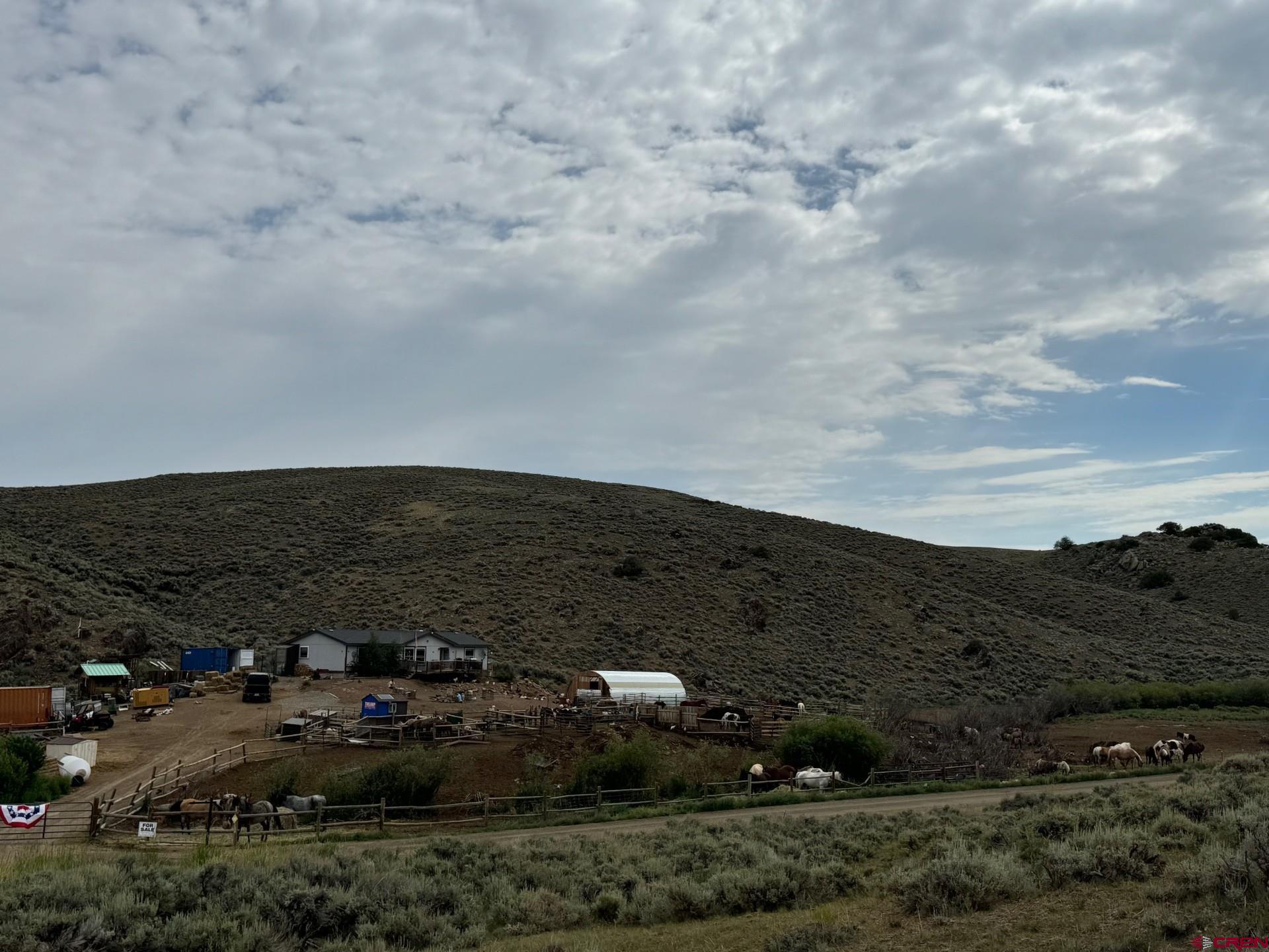 a view of a dry field with lots of house