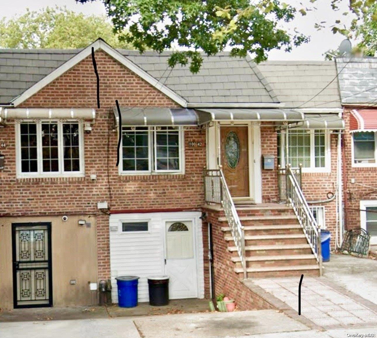 a front view of a house with a bench