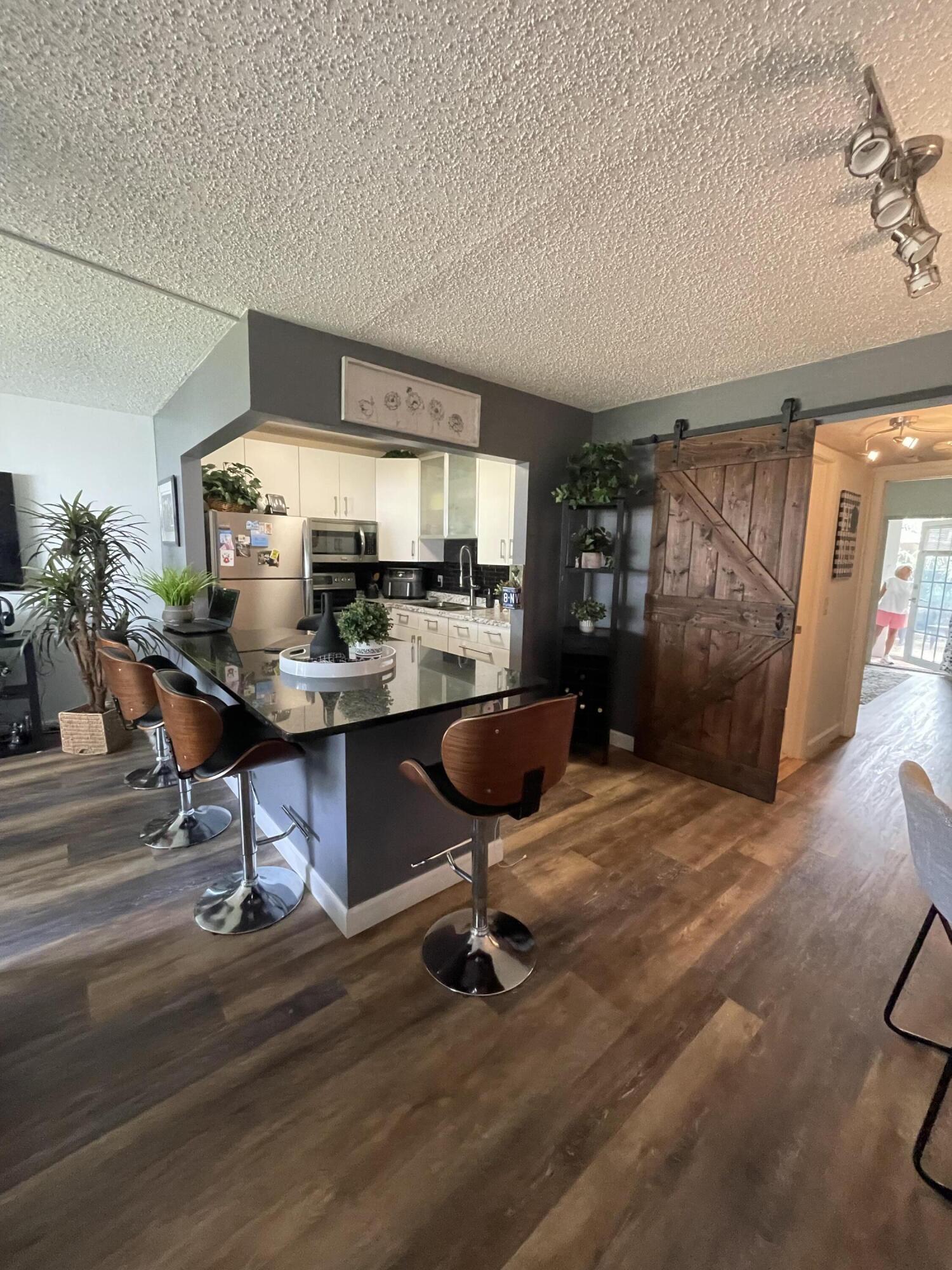 a workspace with furniture and kitchen view