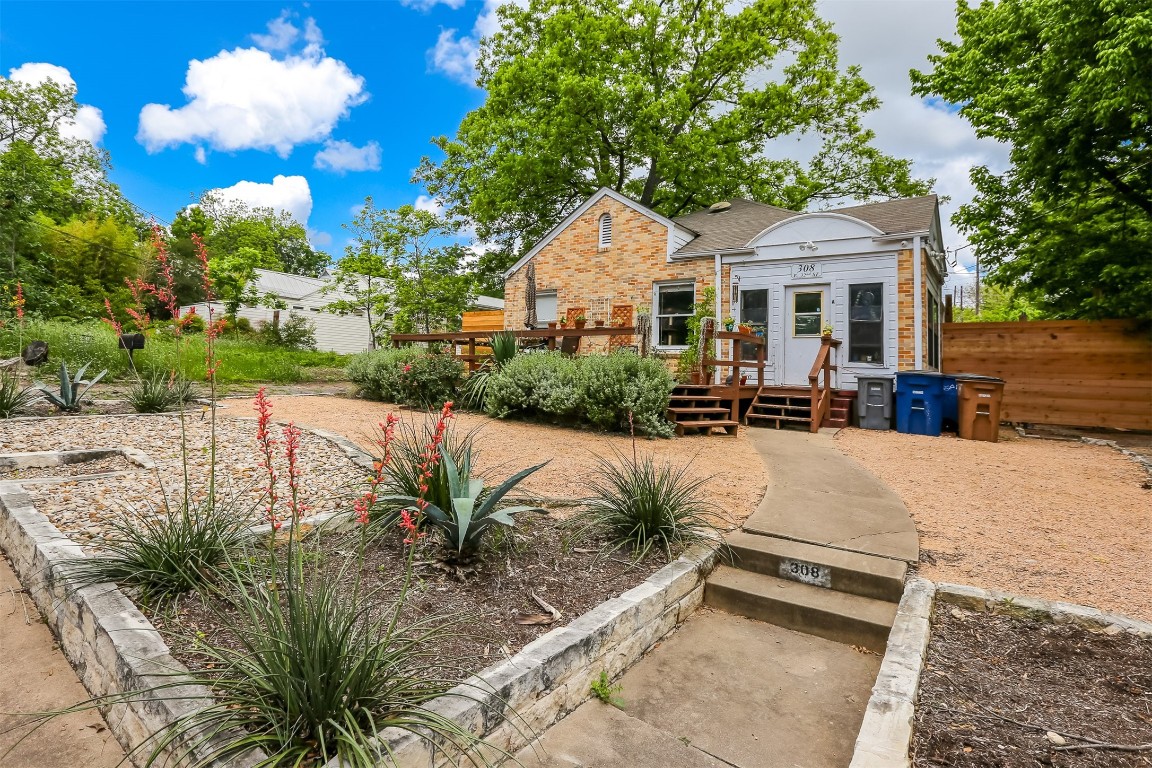 a view of a white house with a yard