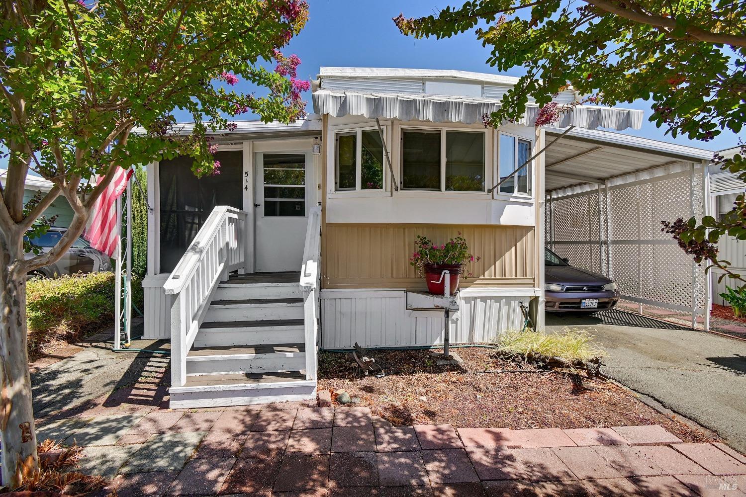 a view of a house with entryway and wooden fence