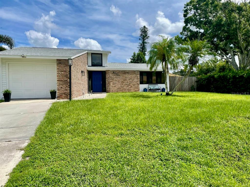 a view of a house with a garden and yard