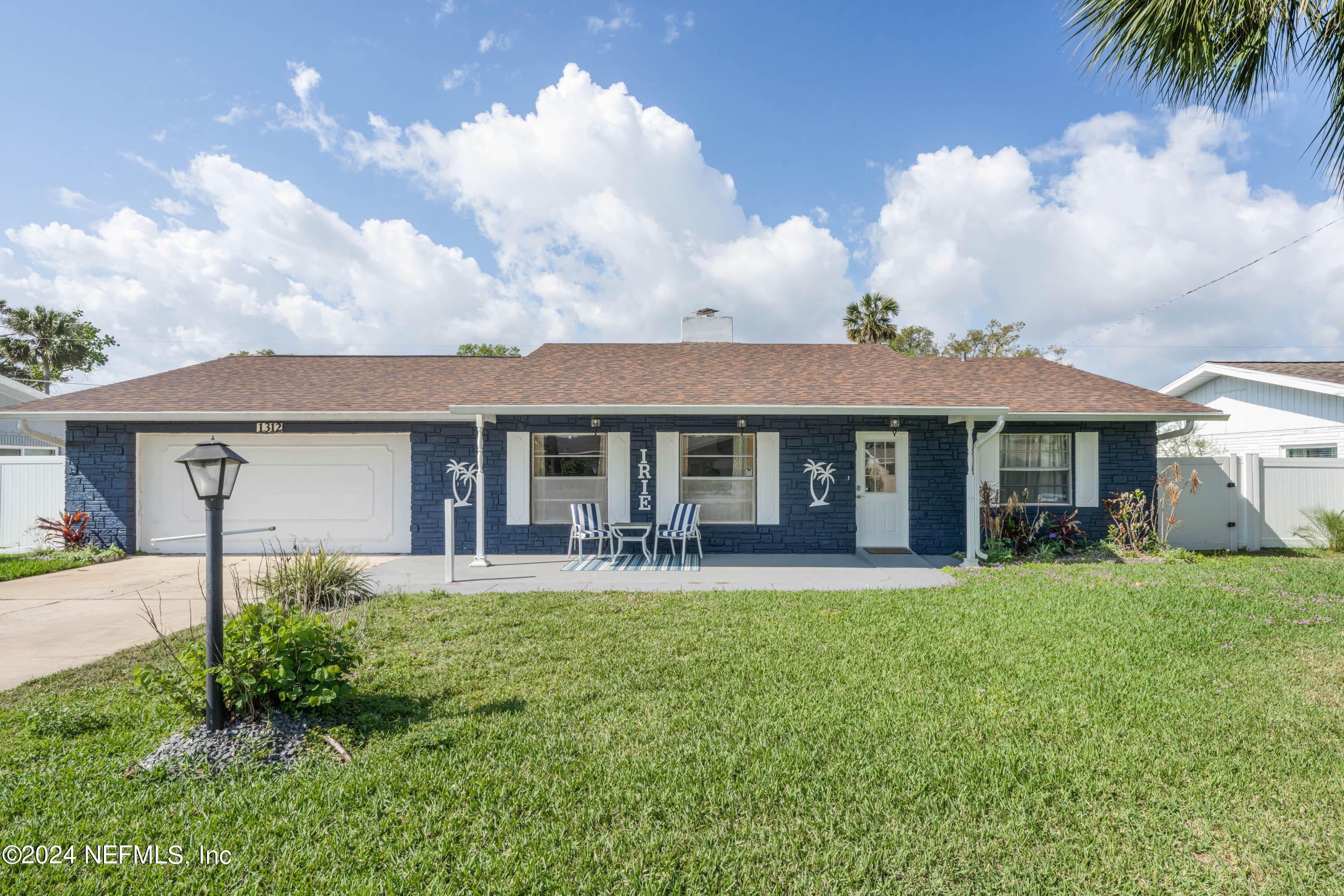 a front view of a house with a yard and porch