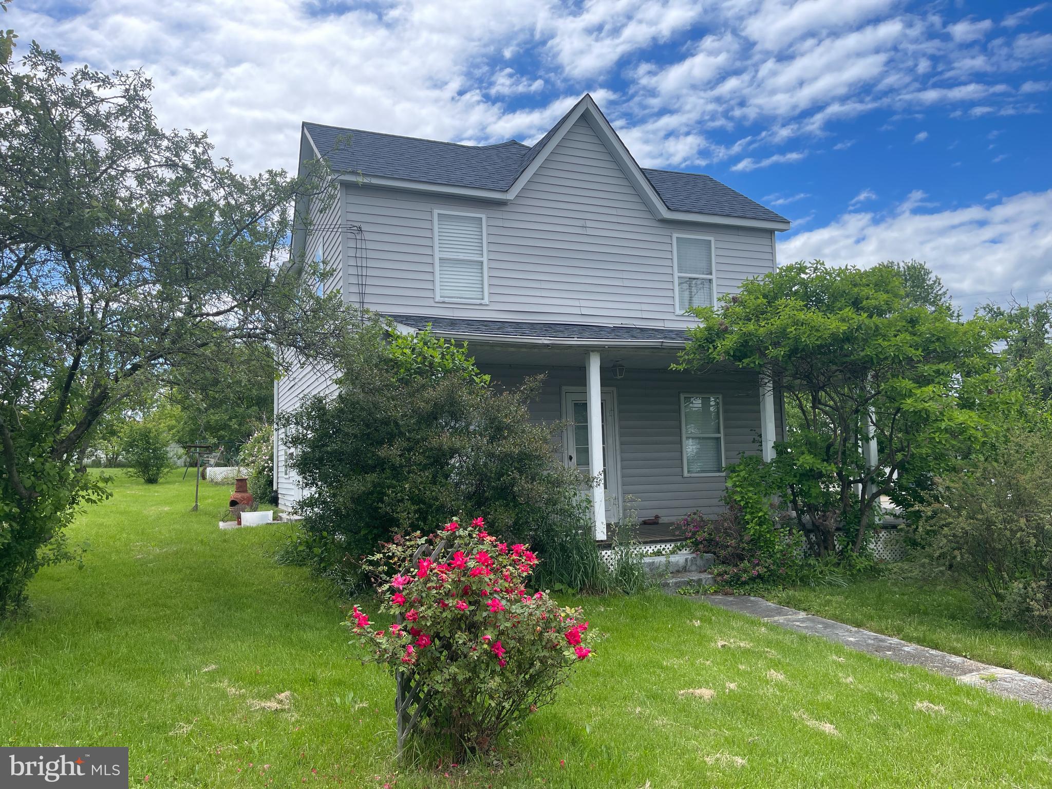 a front view of house with a garden