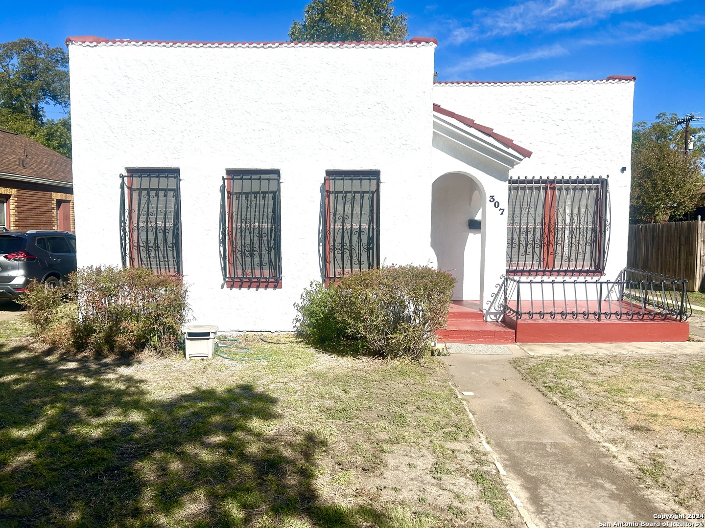 a view of potted plants in front of a house