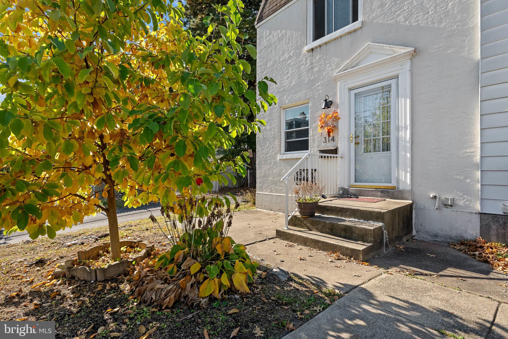 a front view of a house with outdoor seating