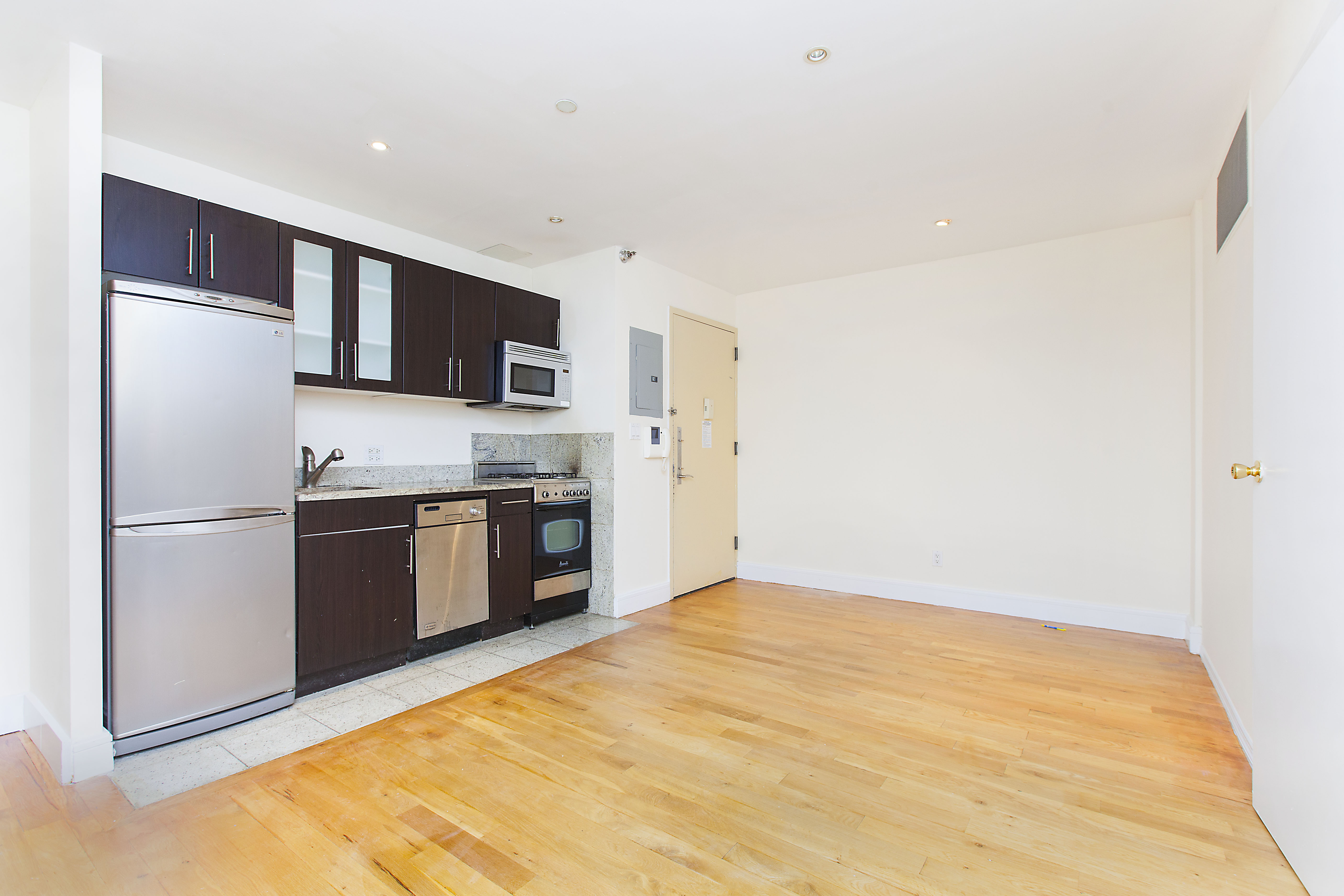 a kitchen with stainless steel appliances a refrigerator and a stove top oven