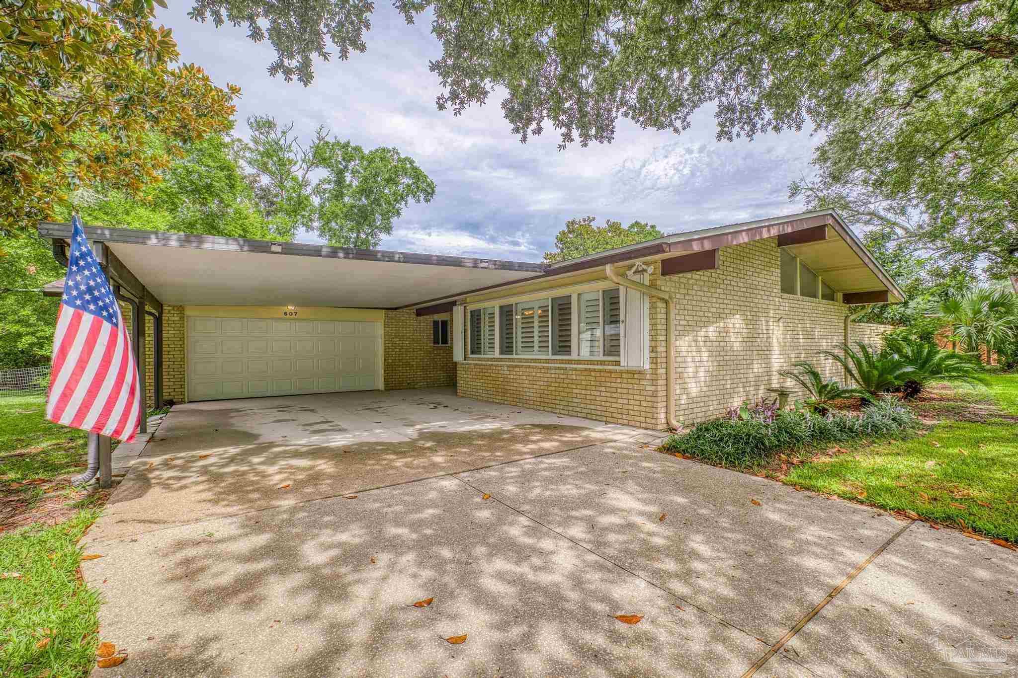 a view of a house with a yard and garage