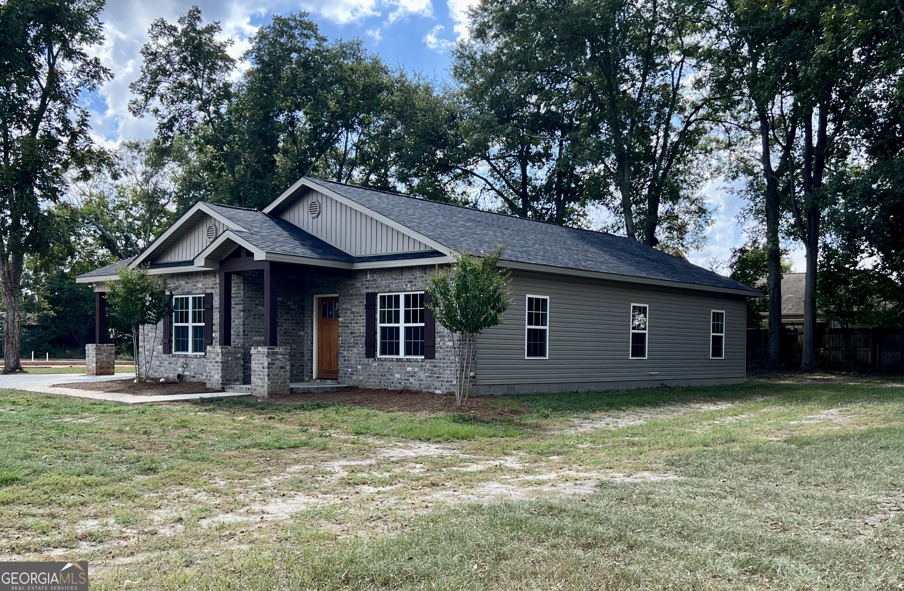 a view of a house with a yard and sitting area