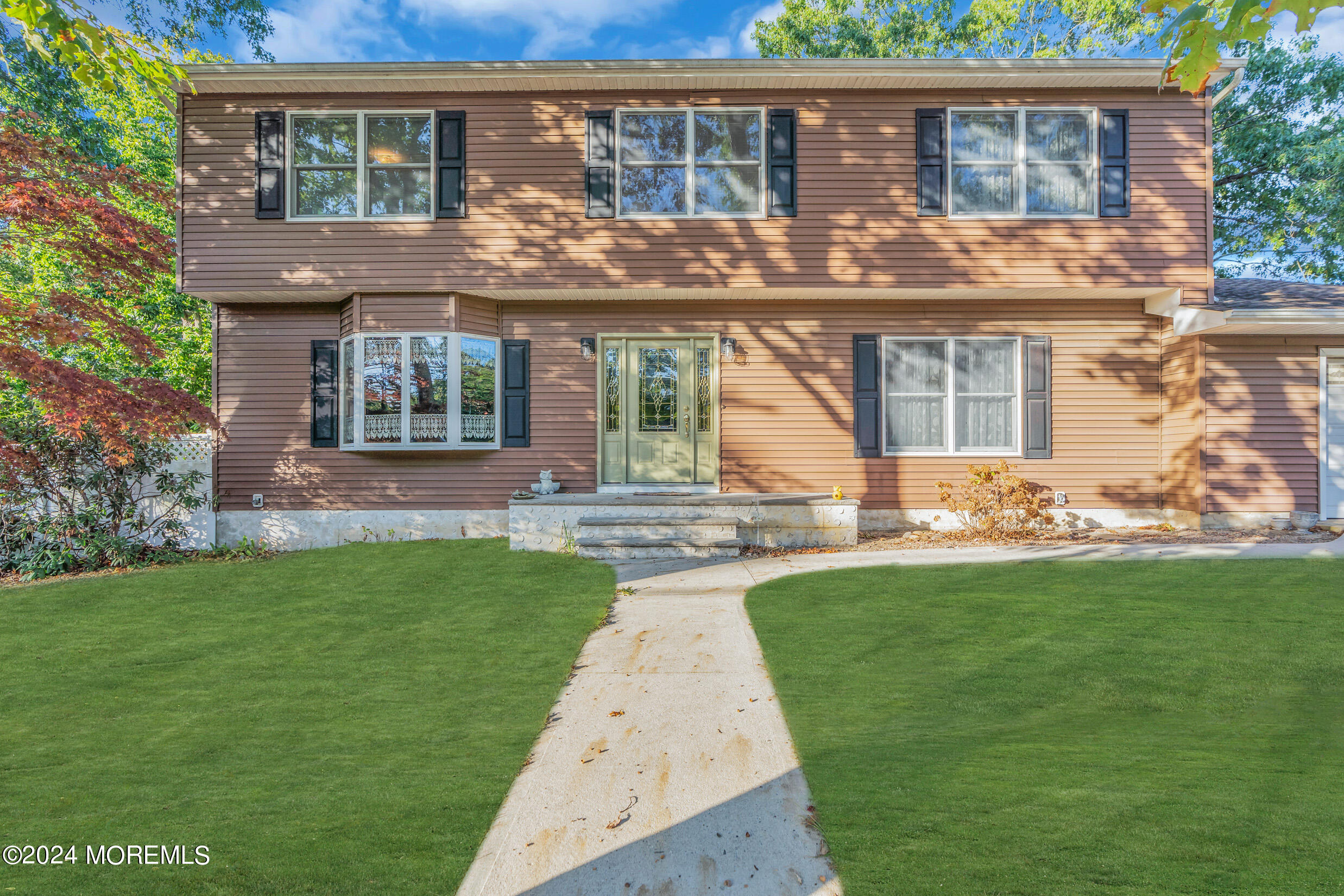 a front view of house with yard and green space