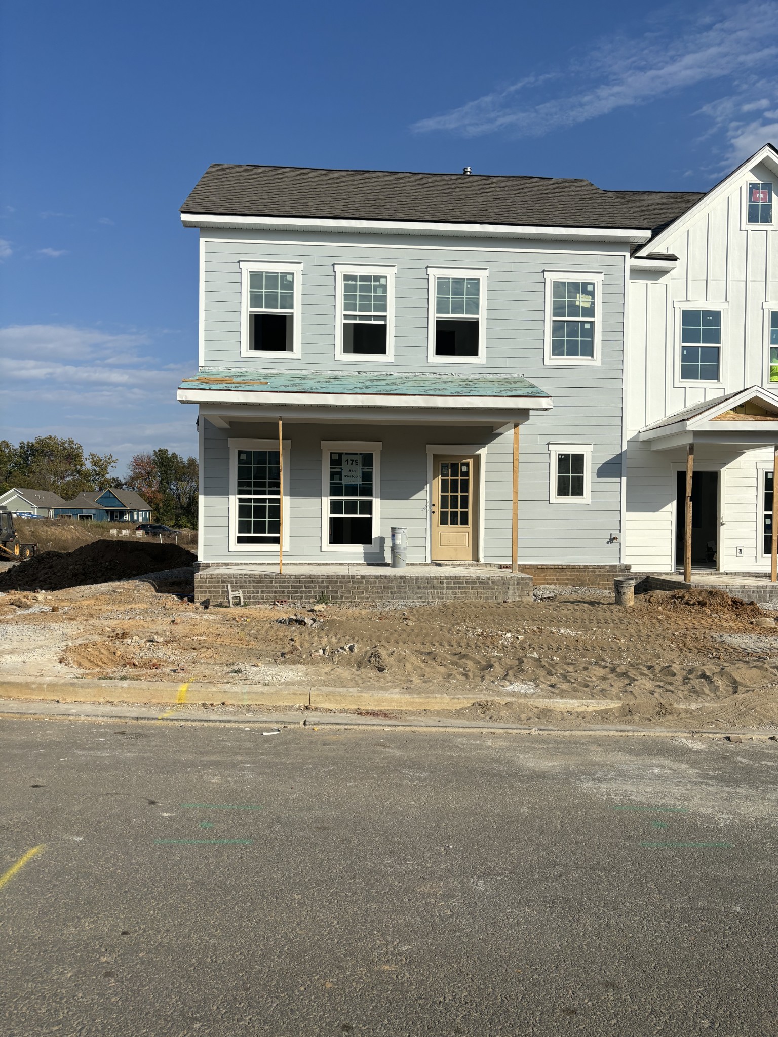 a front view of a house with a road