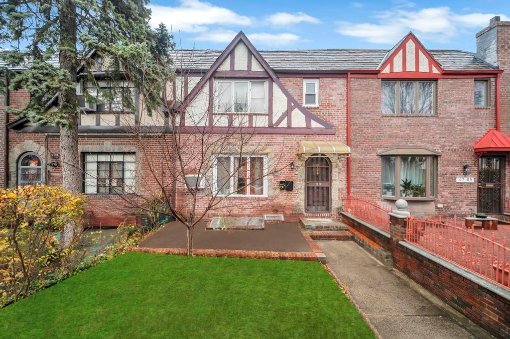 English style home with a front lawn