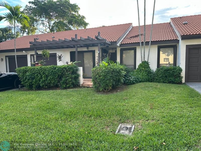 a view of a house with a yard and plants