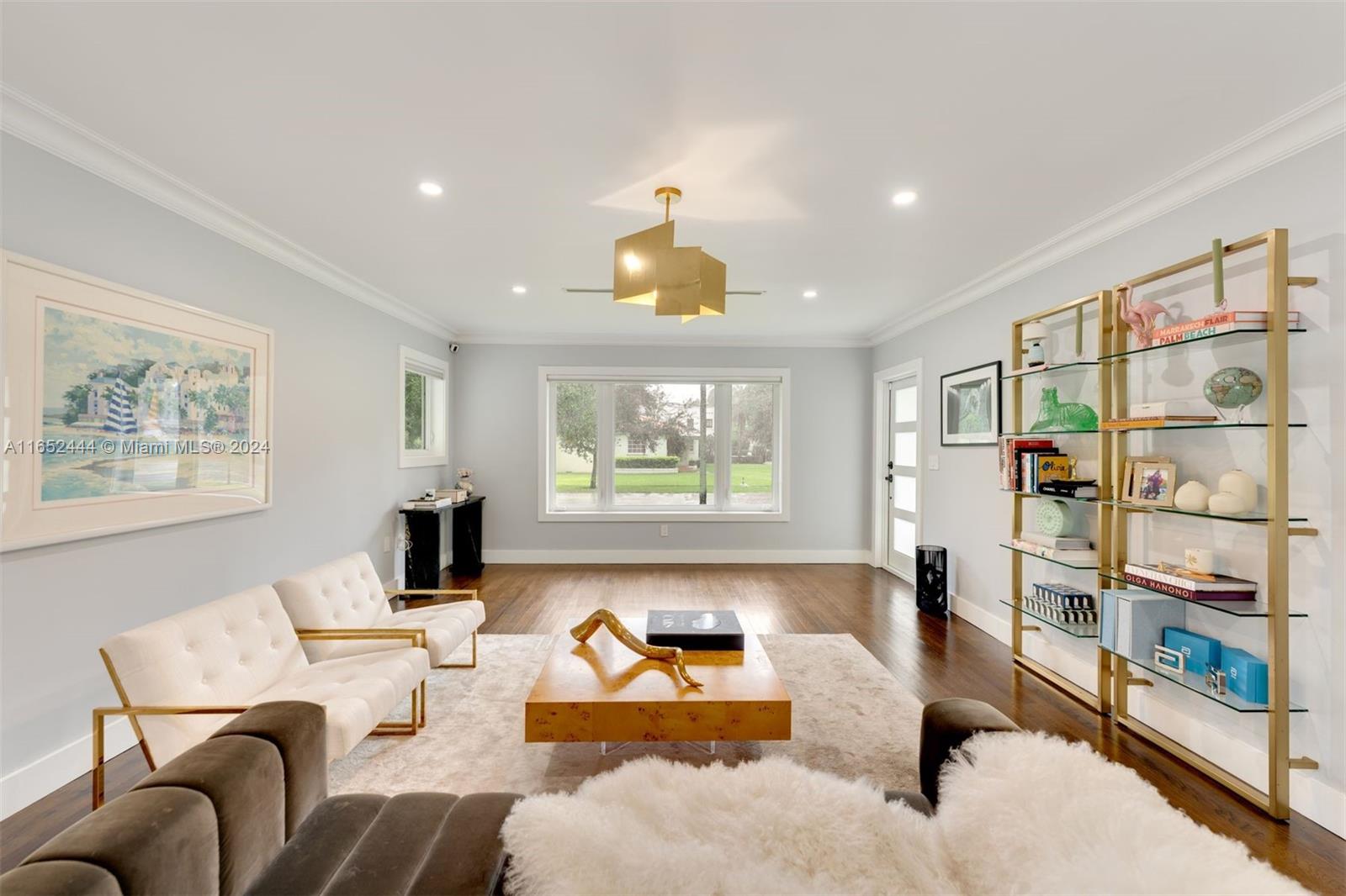 a living room with furniture a window and a flat screen tv