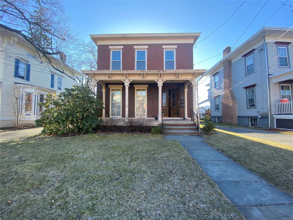 View of front of house featuring a front yard and a porch