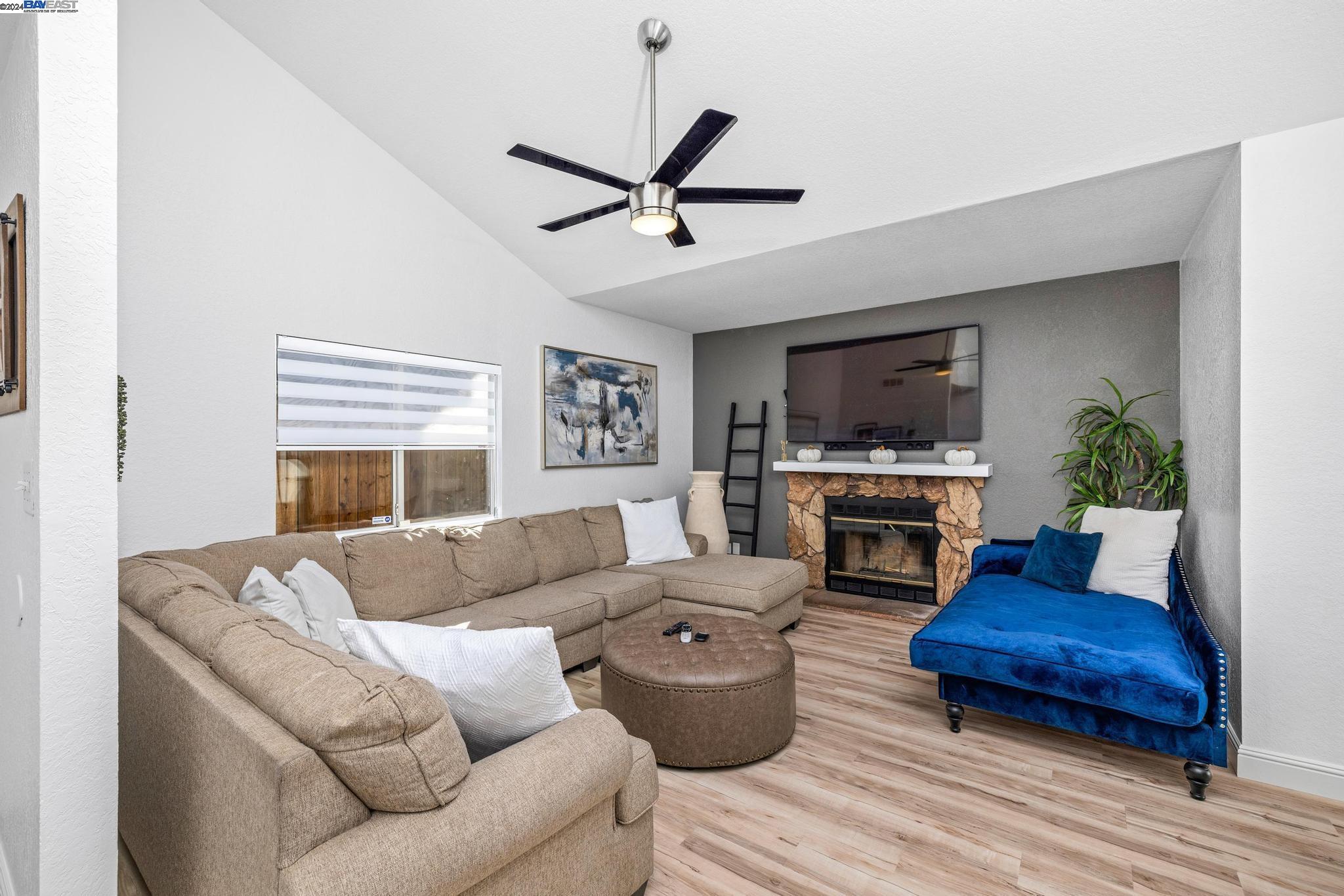 a living room with furniture a fireplace and a flat screen tv