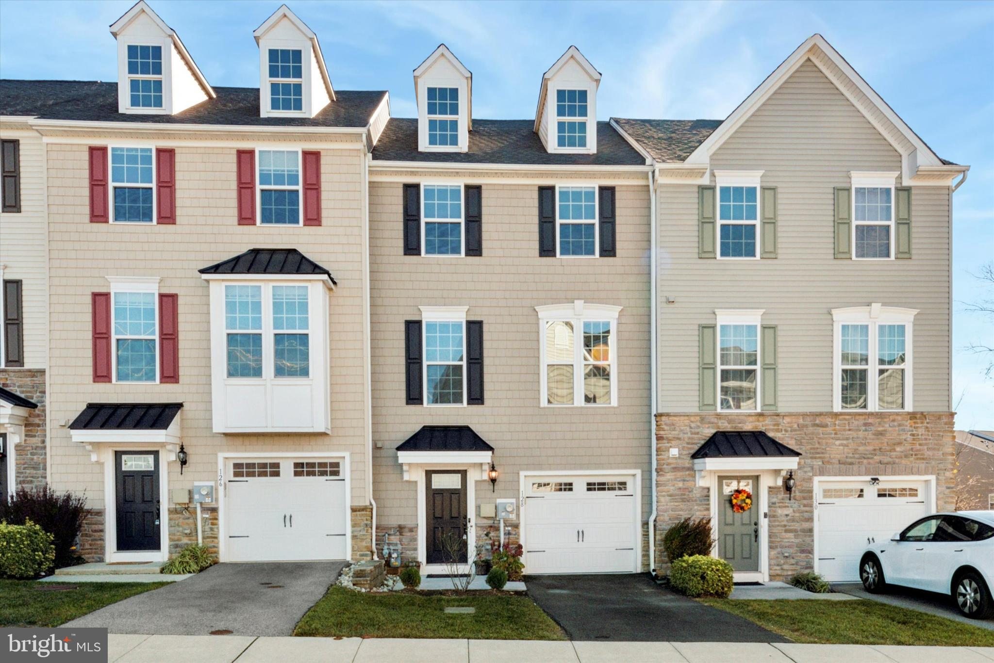 a front view of residential houses with yard