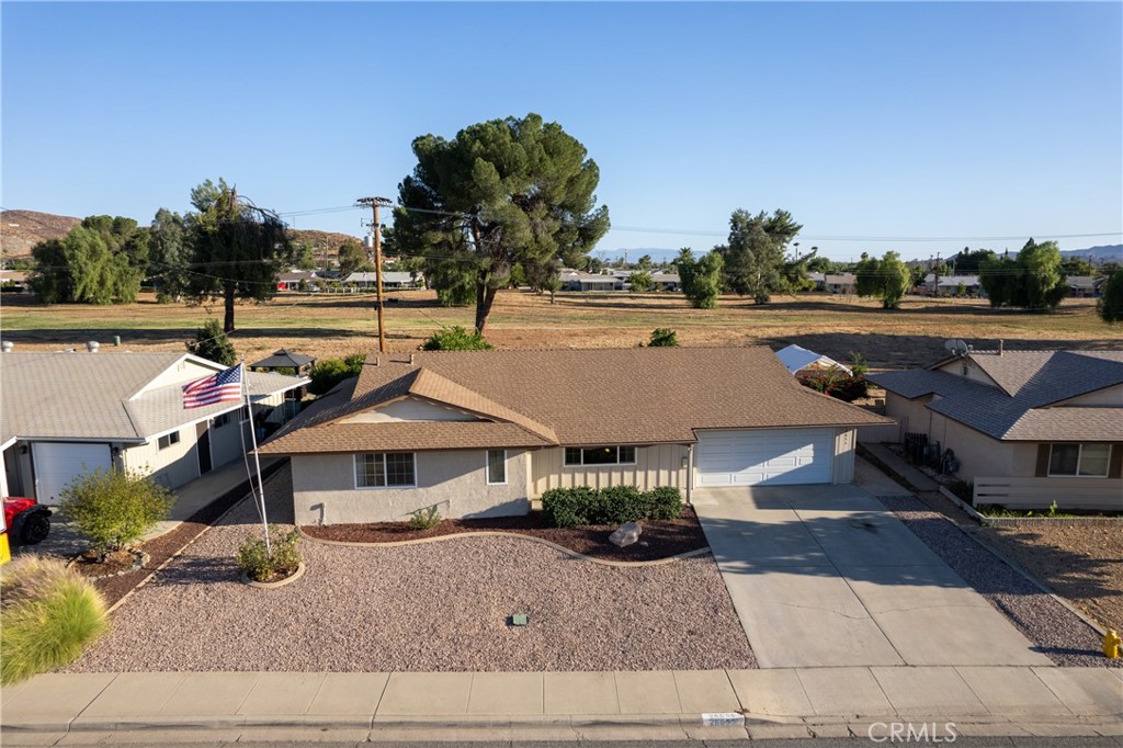 an aerial view of a house with swimming pool and sitting area