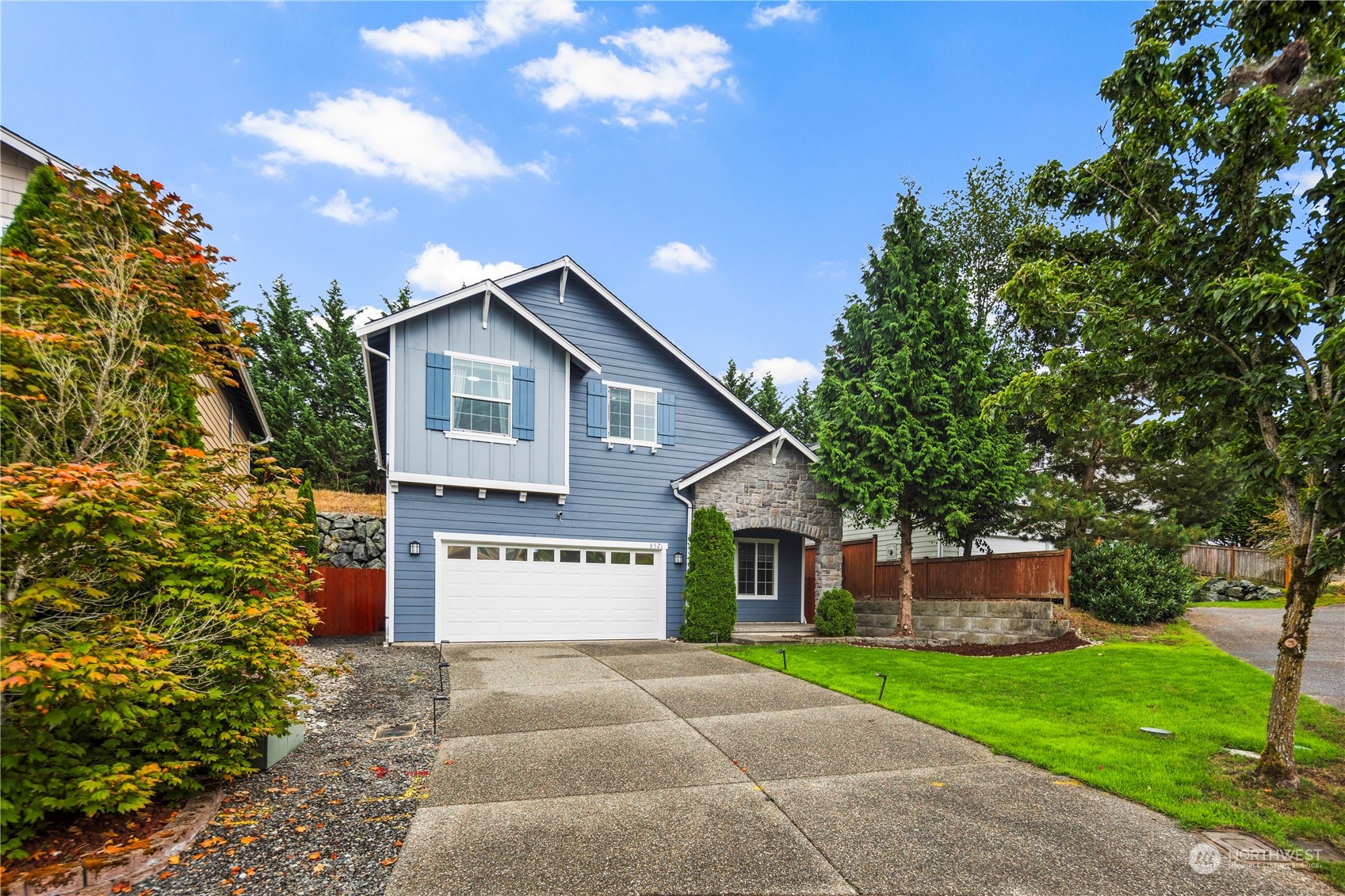 a view of a house with a yard and tree s