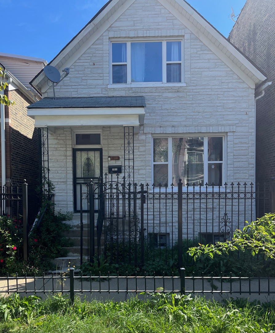 a front view of a house with a garden