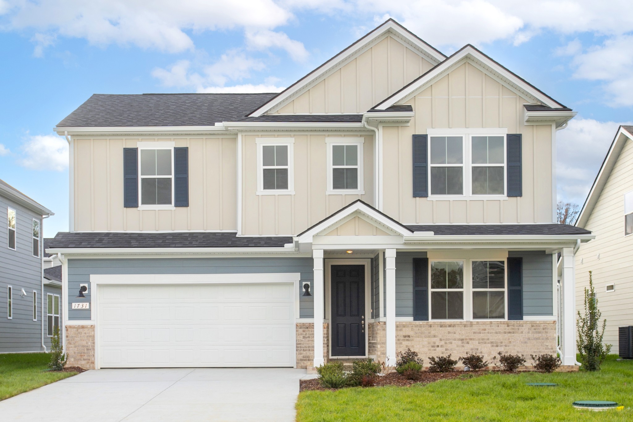 a front view of a house with a yard and garage