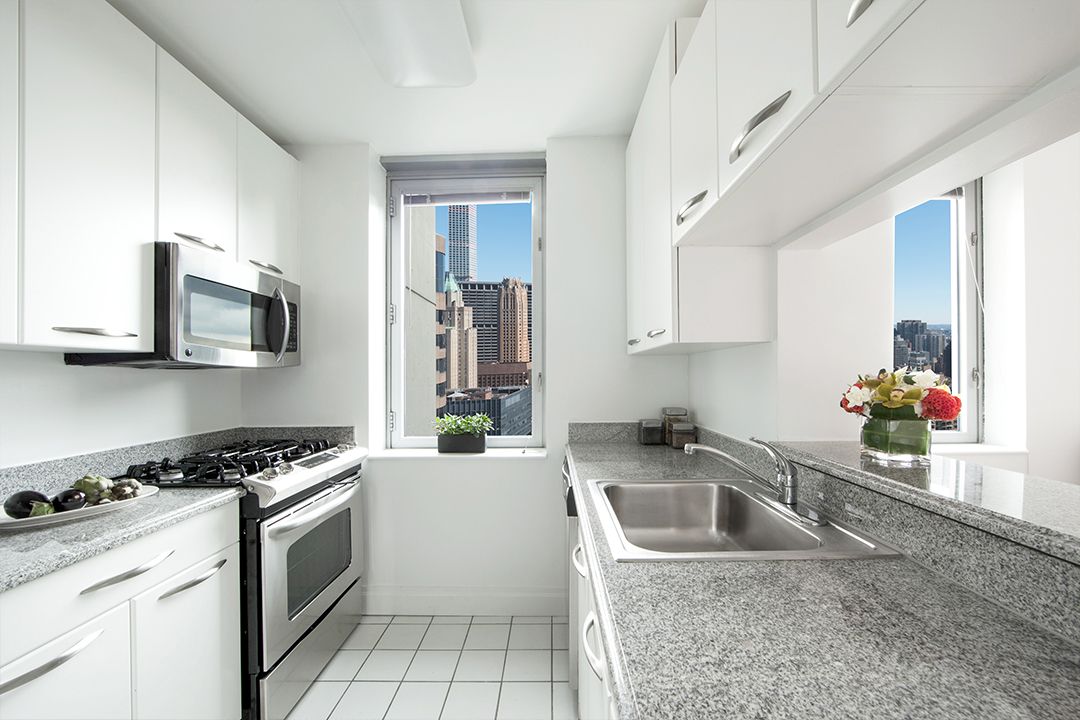 a kitchen that has a sink cabinets counter space and stainless steel appliances