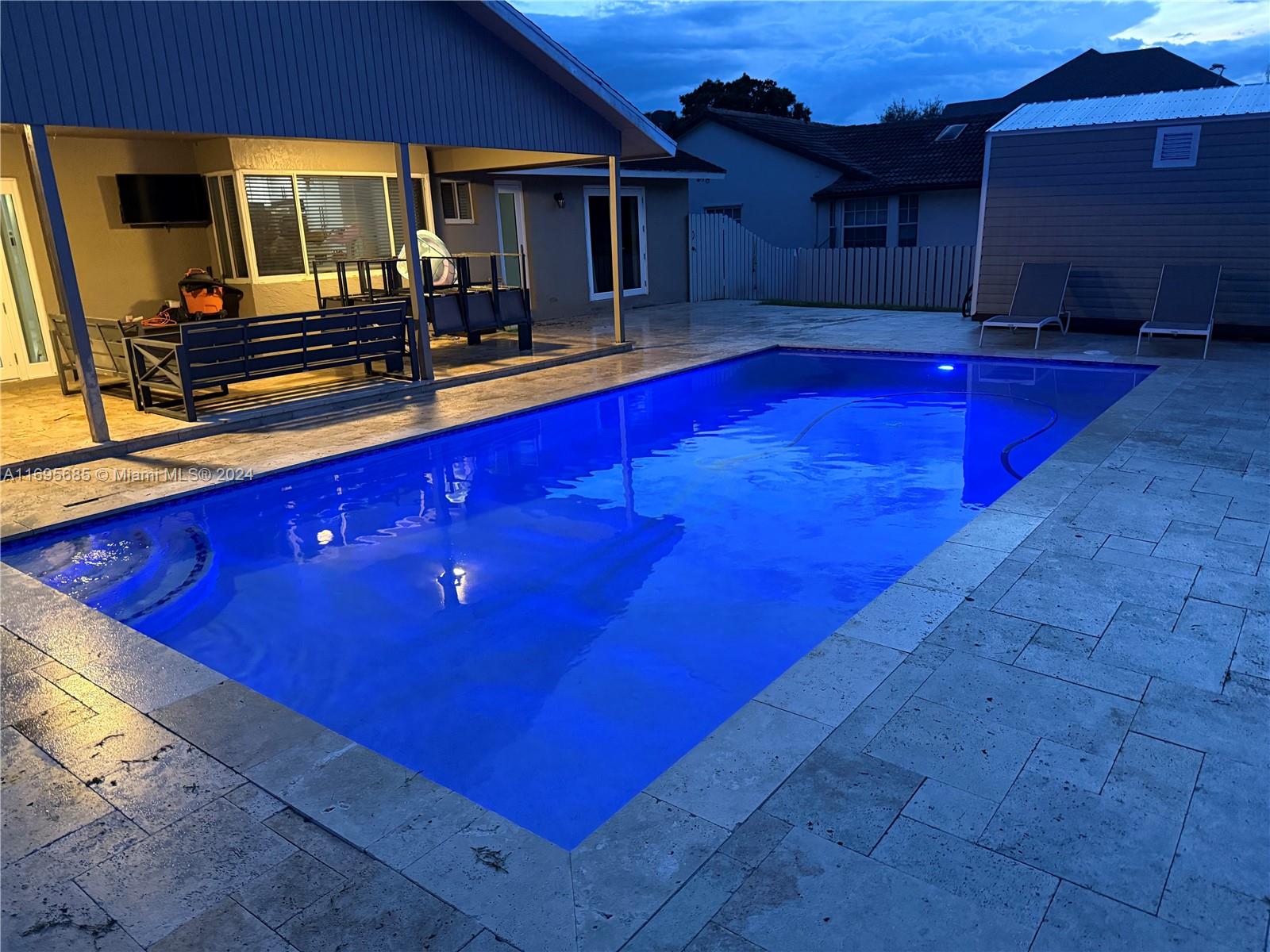 a view of swimming pool with outdoor seating