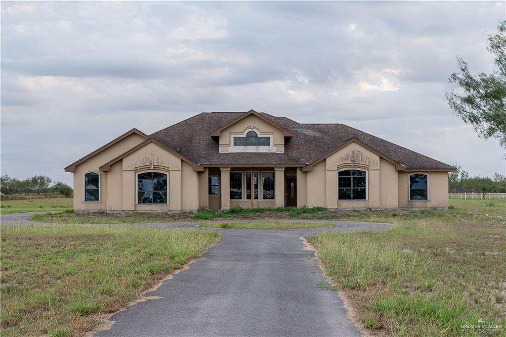 a front view of house with yard and green space