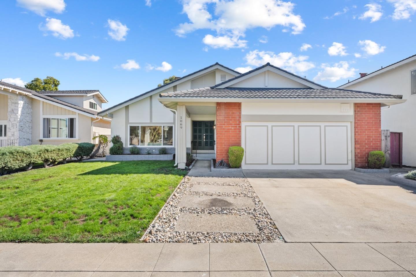 a front view of a house with a yard and garage