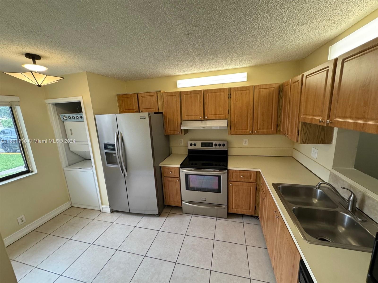 a kitchen with a refrigerator sink and stove