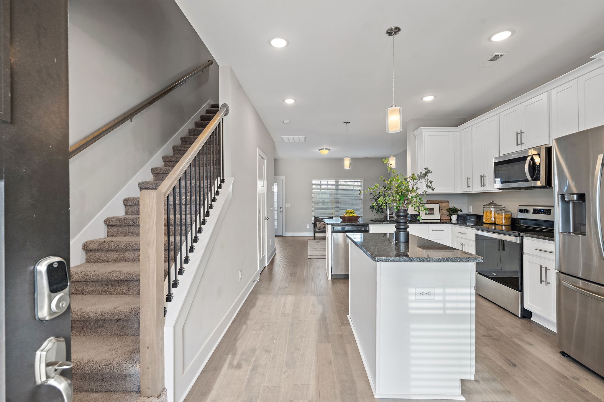 a view of kitchen with cabinets and wooden floor