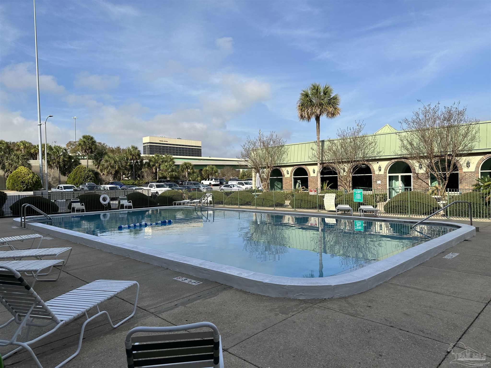 a view of a swimming pool with outdoor seating