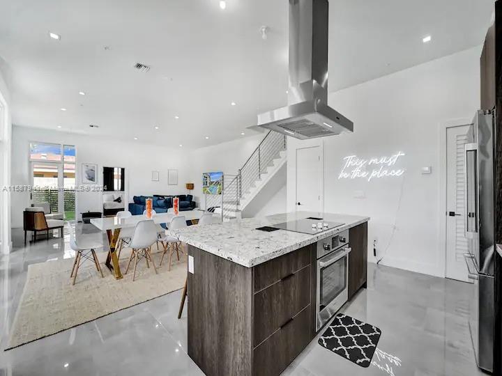 a open kitchen with a table and chairs