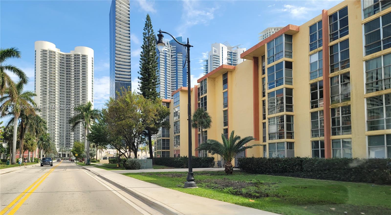 a view of a tall building next to a yard