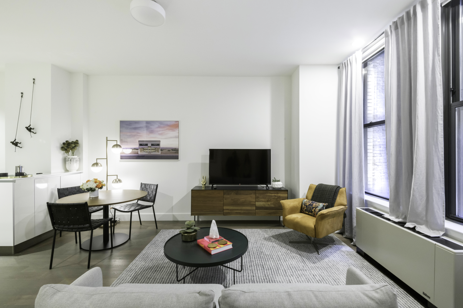 a living room with furniture a rug and a flat screen tv